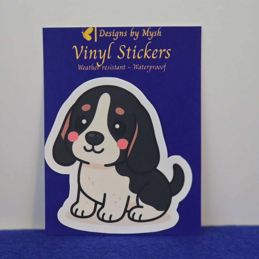 Basset Hound Black white and tan kawaii style sticker on a blue background.