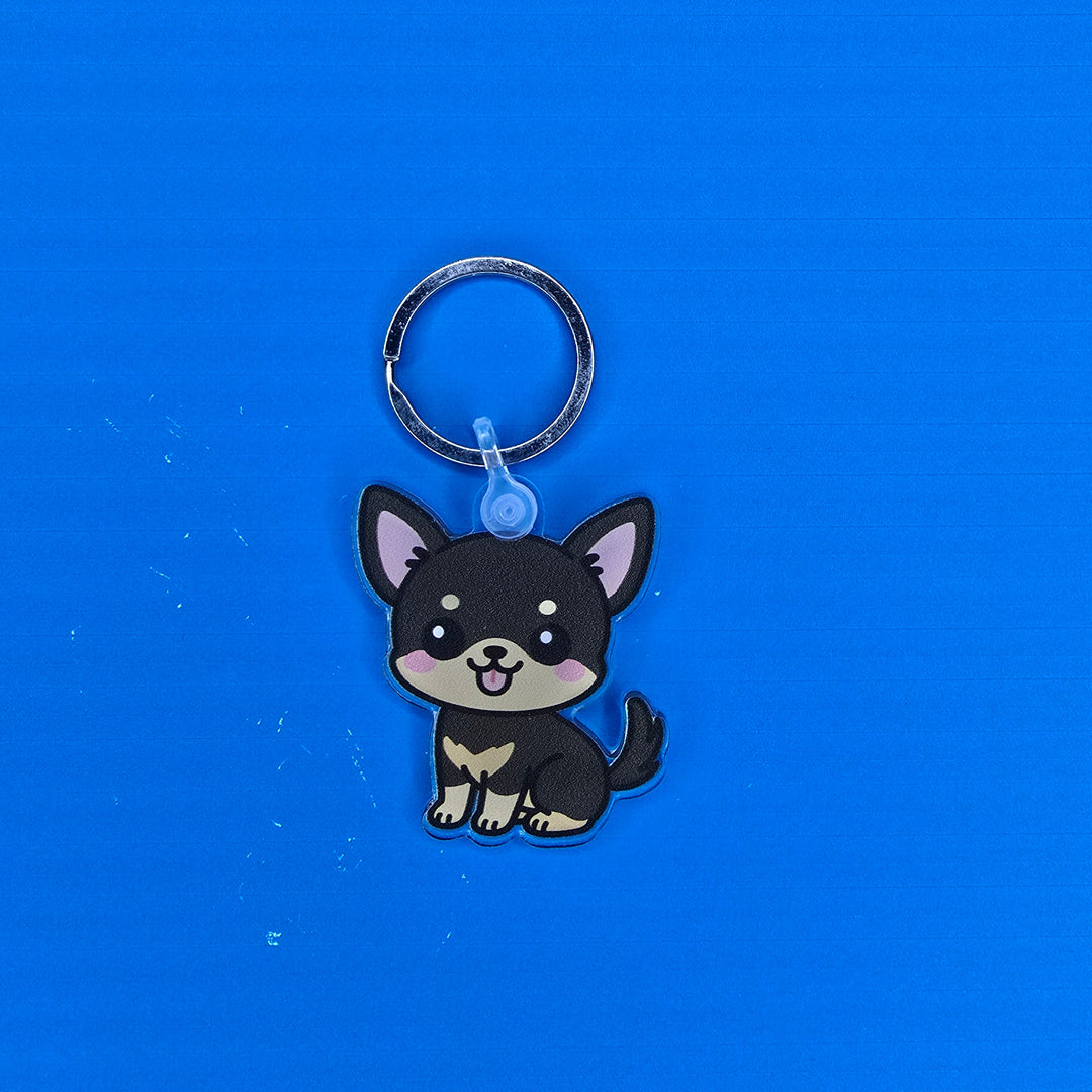 Keychain with a cartoon dog design on a blue background
