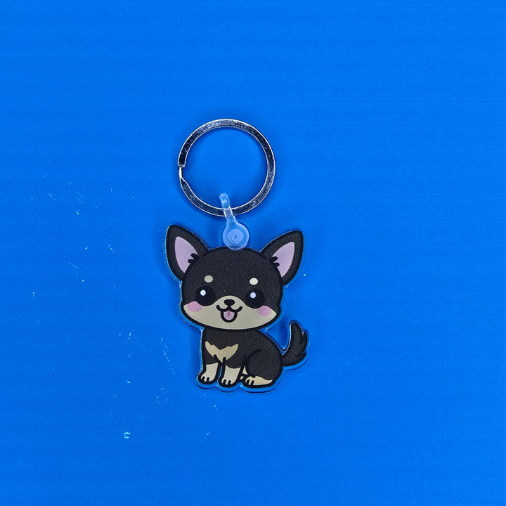 Keychain with a cartoon dog design on a blue background