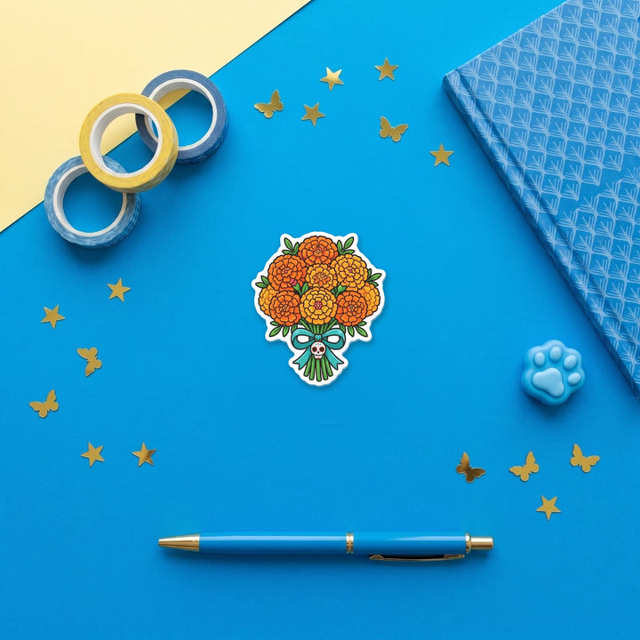 Marigold Bouquet 3 inch fridge magnet flat lay with blue stationery