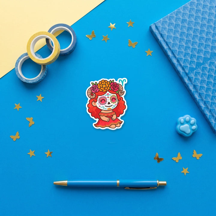 Aries Sugar Skull Girl 3 inch fridge magnet flat lay with blue stationery
