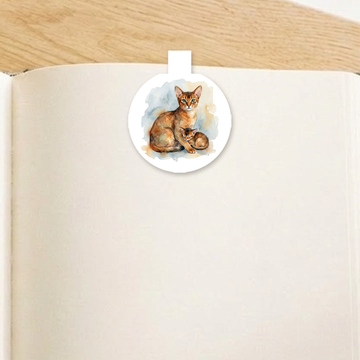 Abyssinian mama cat and kitten magnetic bookmark clipped over the top of an open book page – Designs by Mysh