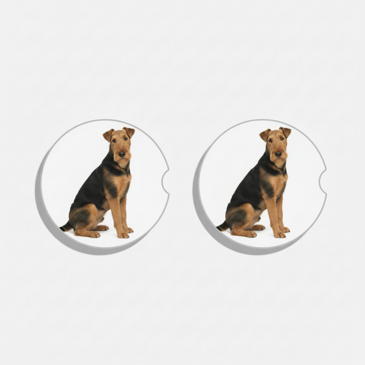Two circular dog-themed coasters with a sitting dog design on a white background