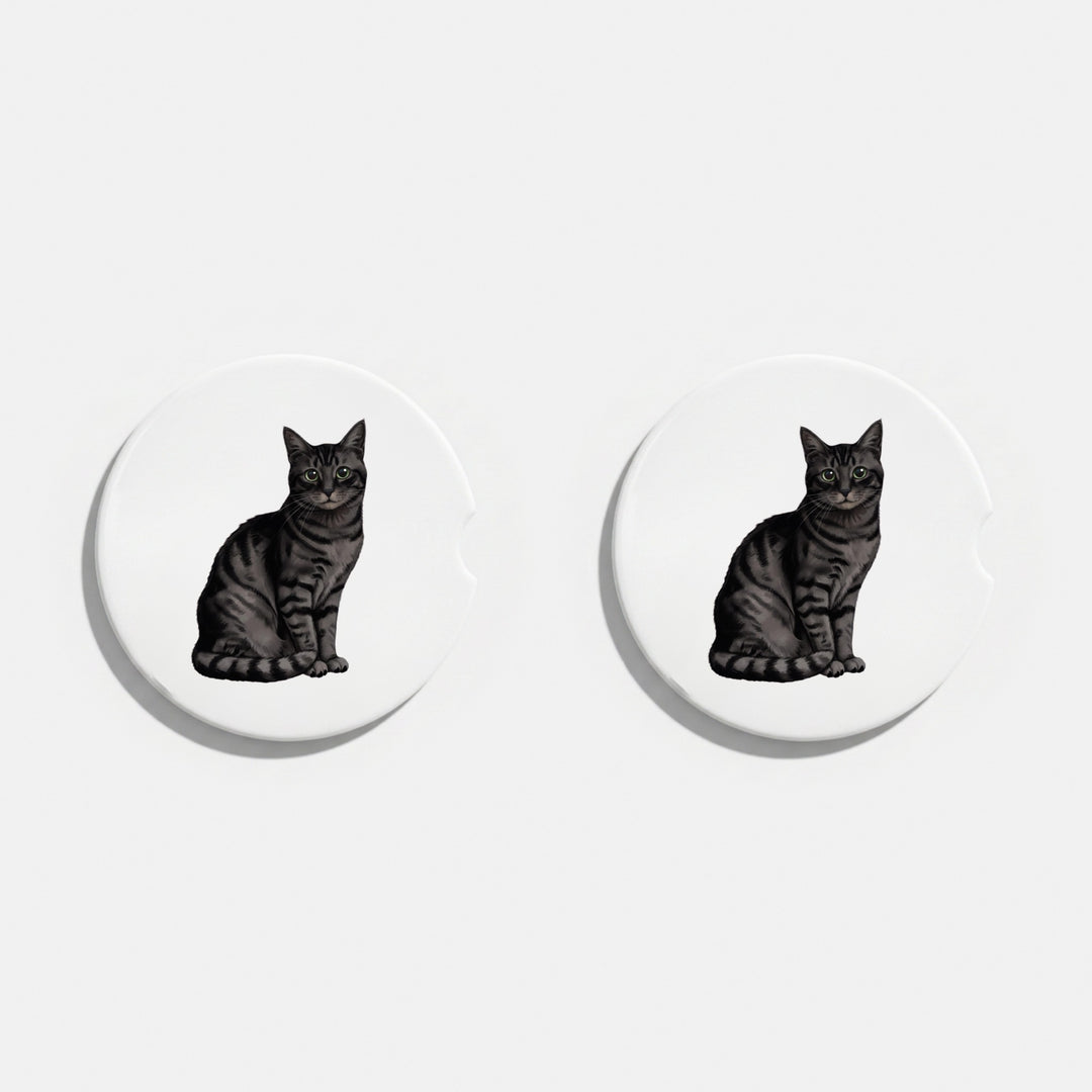 Set of two round ceramic car coasters featuring a watercolor-style illustration of an American Shorthair cat with a black tabby coat.