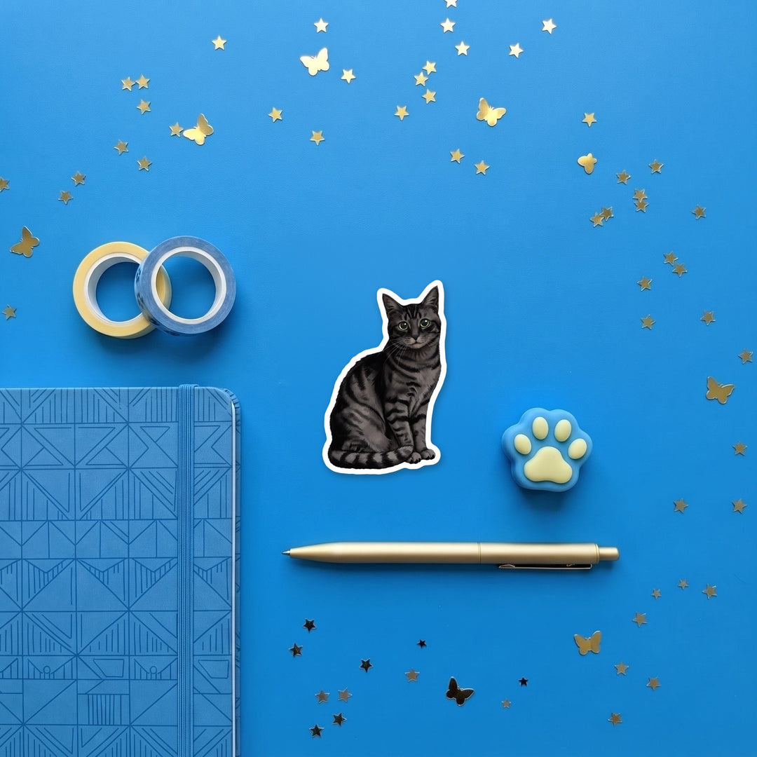 American Shorthair Black Tabby watercolor 3 inch sticker flat lay with blue and yellow stationery – Designs by Mysh
