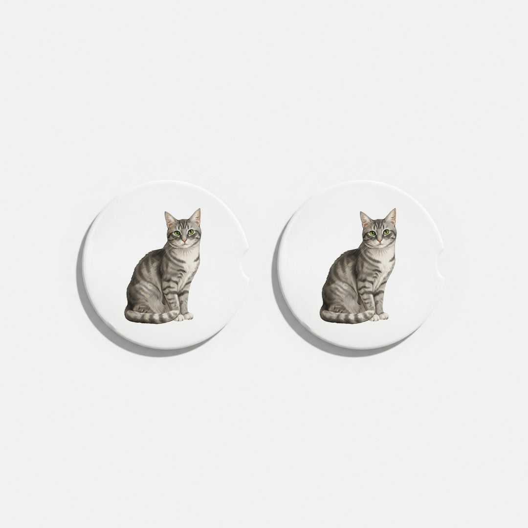 Set of two round ceramic car coasters featuring a watercolor-style illustration of an American Shorthair cat with a gray tabby coat.