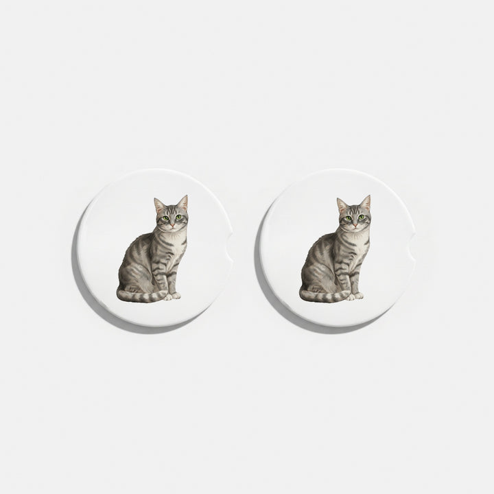 Set of two round ceramic car coasters featuring a watercolor-style illustration of an American Shorthair cat with a gray tabby coat.