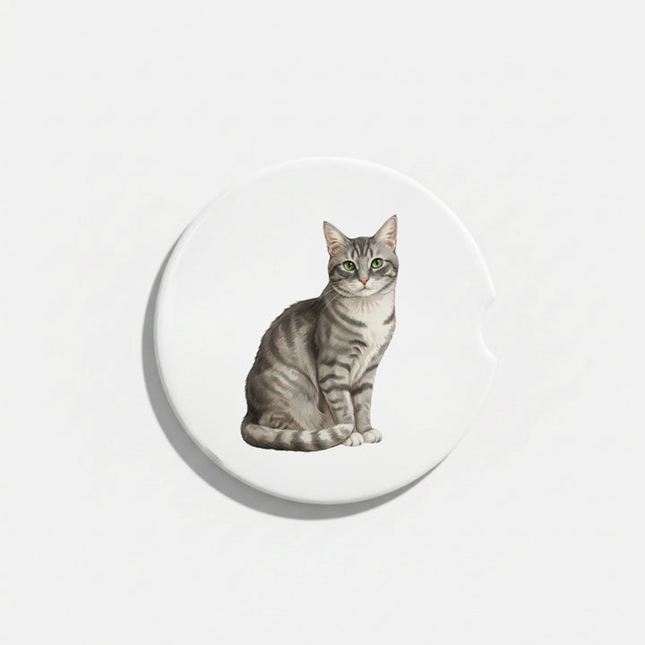 Single round ceramic car coaster featuring a watercolor-style illustration of an American Shorthair cat with a gray tabby coat, sold individually.