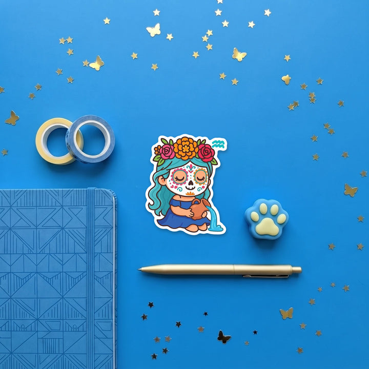 Aquarius sugar skull girl 3 inch sticker flat lay with blue and yellow stationery – Designs by Mysh