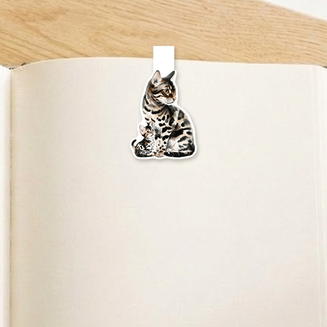 Brown spotted Bengal mama cat and kitten magnetic bookmark clipped over the top of an open book page – Designs by Mysh