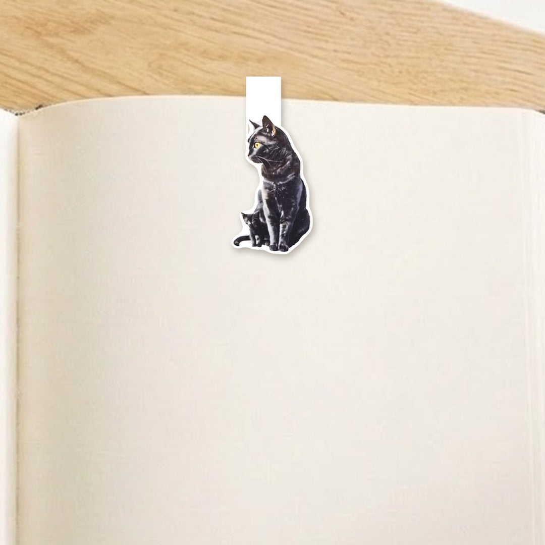 Black mama cat and kitten magnetic bookmark clipped over the top of an open book page – Designs by Mysh