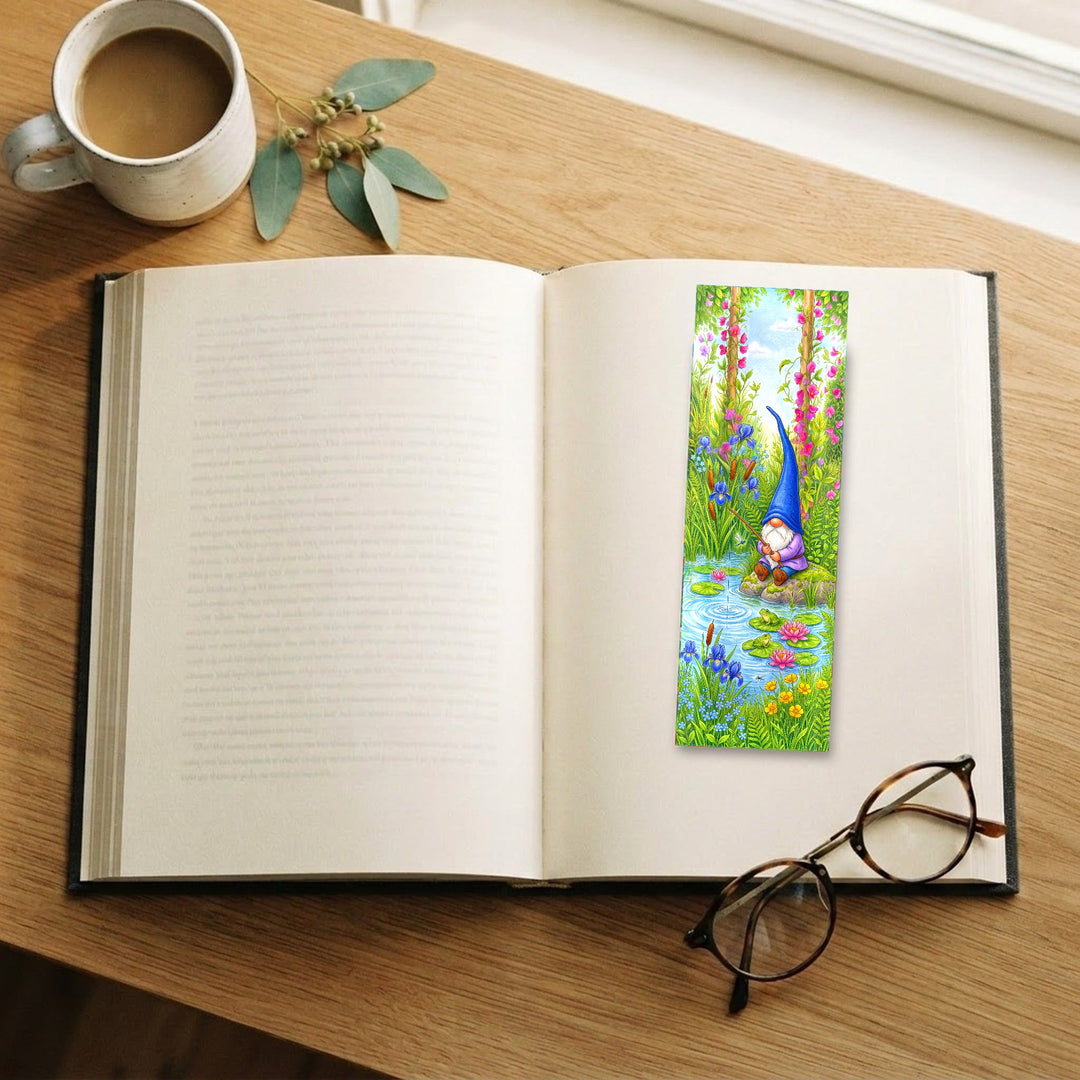 Blue Gnome Fishing Pond bookmark on an open book with coffee and glasses - Designs by Mysh
