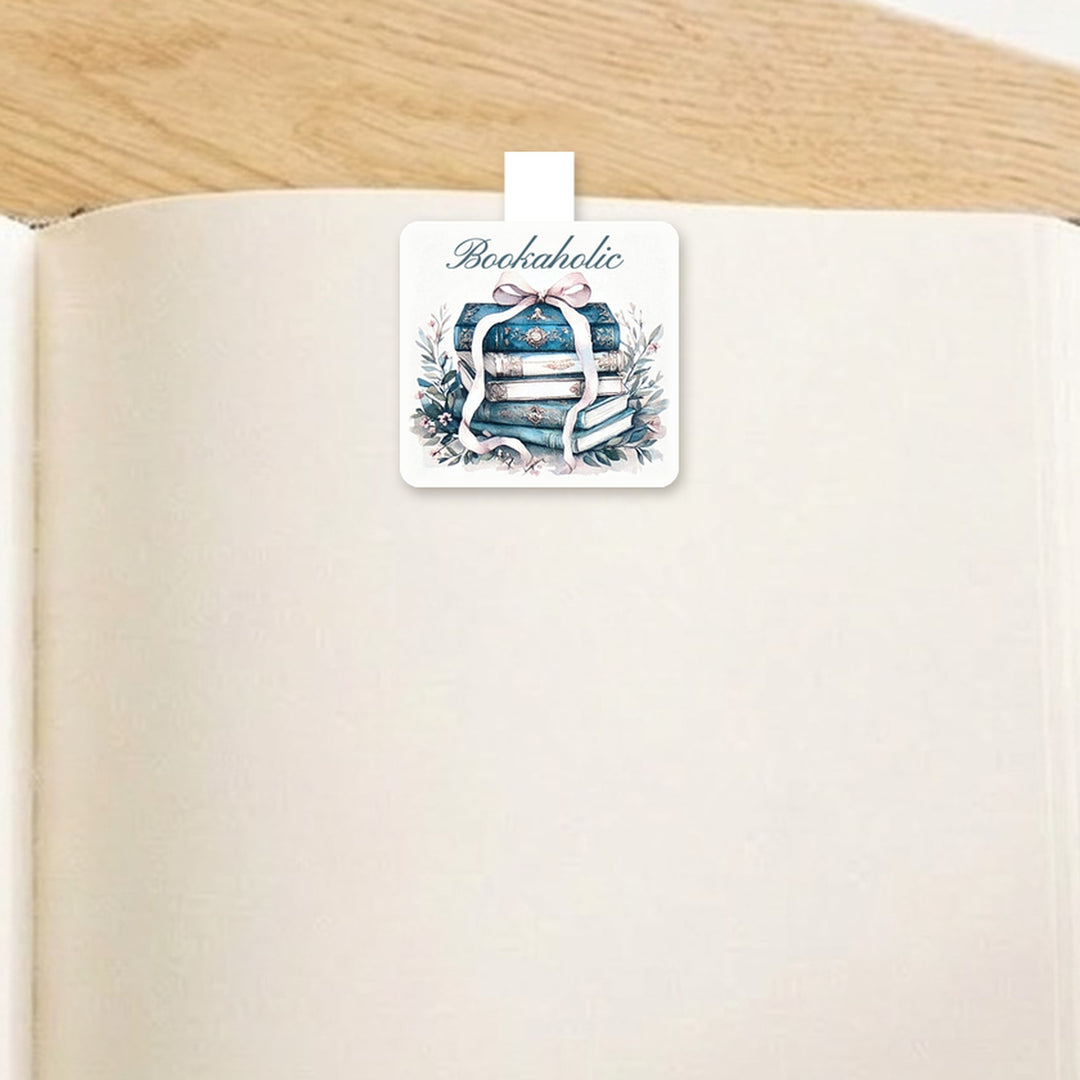 Bookaholic vintage book stack magnetic bookmark clipped over the top of an open book page – Designs by Mysh