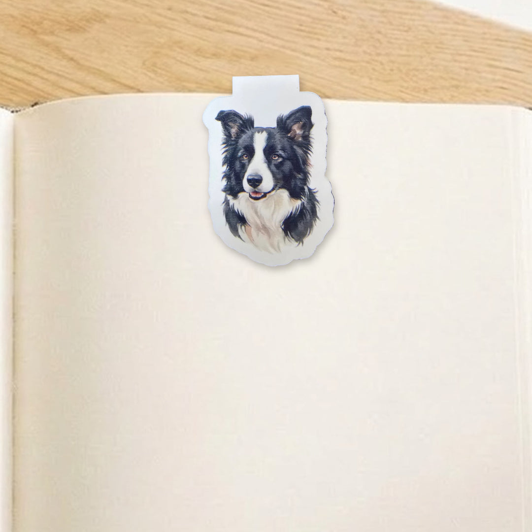 Border Collie watercolor magnetic bookmark clipped over the top of an open book page – Designs by Mysh
