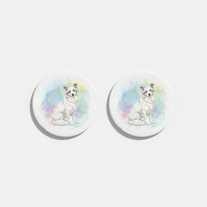 Set of two round ceramic car coasters featuring a watercolor-style illustration of a Border Collie with a white coat with ticking.