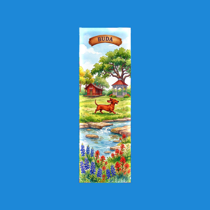 Buda Texas watercolor 2x6 bookmark with a red dachshund trotting past the historic depot and gazebo, with Onion Creek below - Designs by Mysh