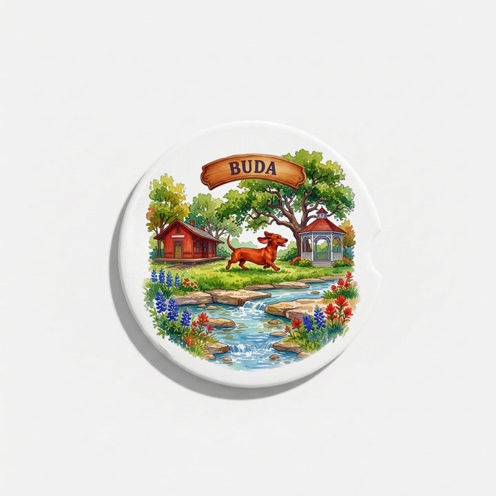Single round ceramic car coaster with a watercolor Buda, Texas design, sold individually – Designs by Mysh