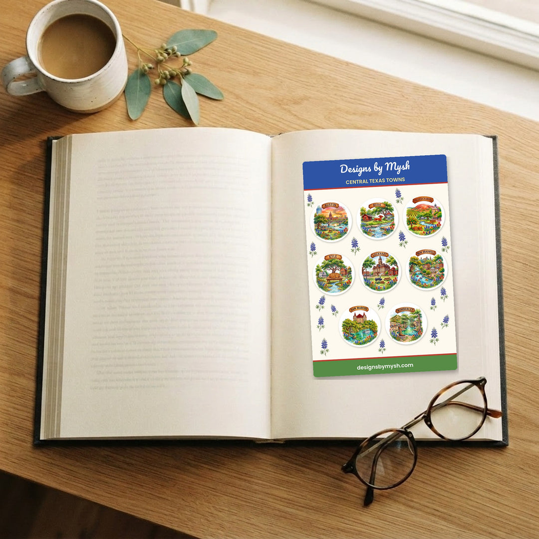 Central Texas Towns sticker sheet on an open book with coffee and reading glasses – Designs by Mysh