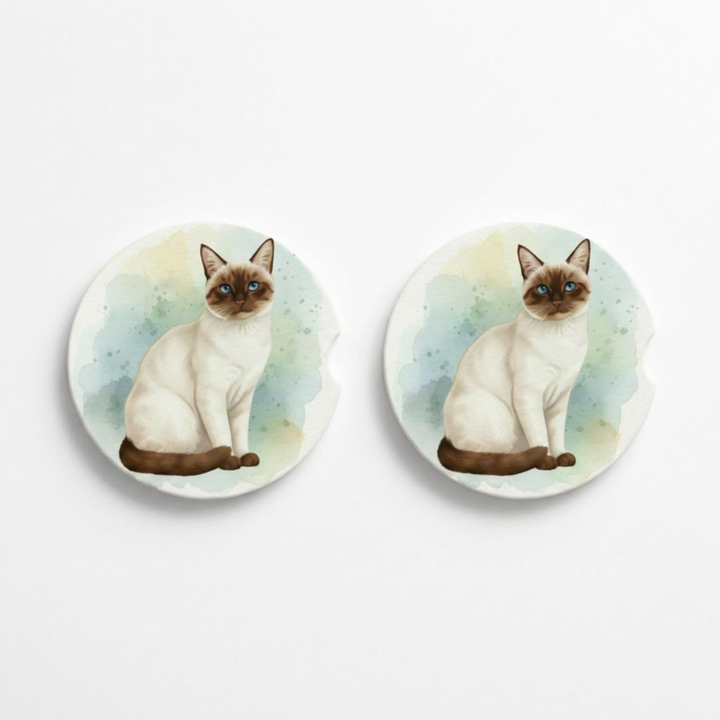 Set of two round ceramic car coasters featuring a watercolor-style illustration of a Siamese cat with a chocolate point coat.