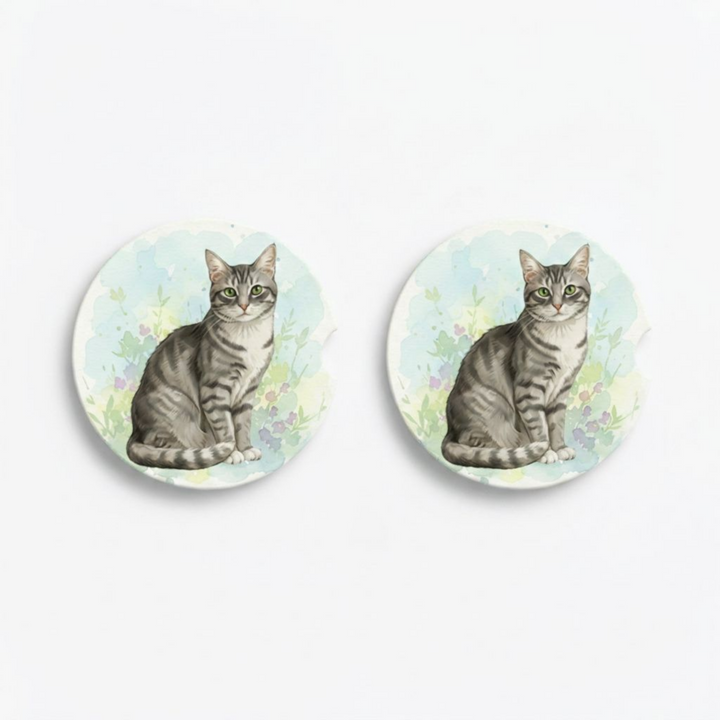 Set of two round ceramic car coasters featuring a watercolor-style illustration of an American Shorthair cat with a gray tabby coat.