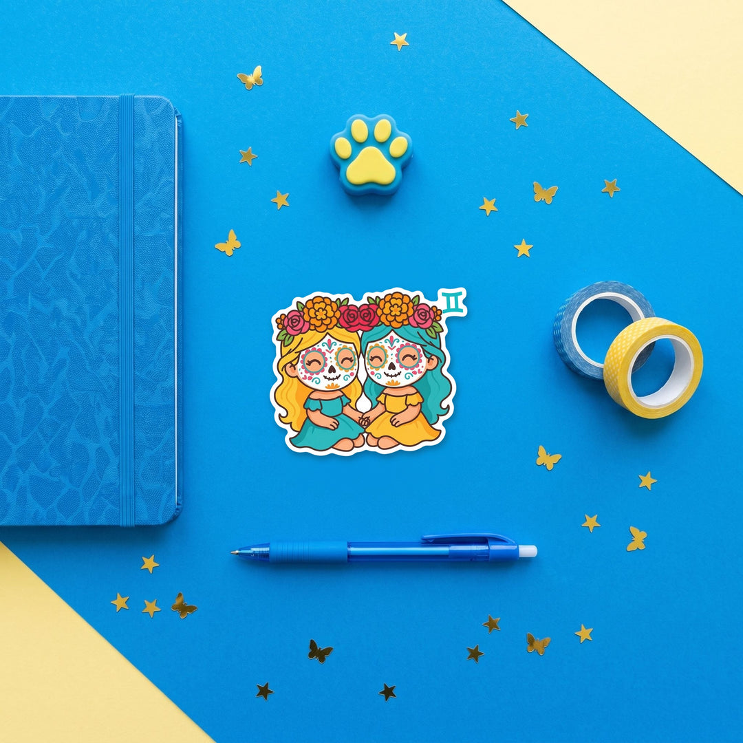 Gemini sugar skull girls 3 inch sticker flat lay with blue and yellow stationery – Designs by Mysh