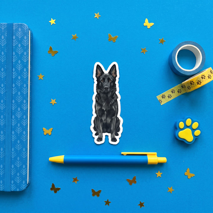Black German Shepherd watercolor vinyl sticker 3 inch flat lay with blue and yellow stationery – Designs by Mysh