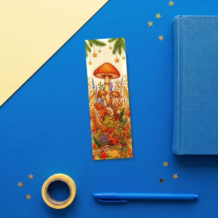 Hedgehog Mushroom Reading 2x6 inch bookmark flat lay with blue book and stationery - Designs by Mysh