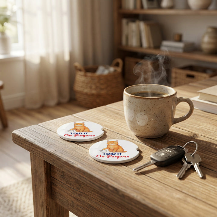 Two I Did It On Purpose car coasters on a wooden table with a mug and car keys