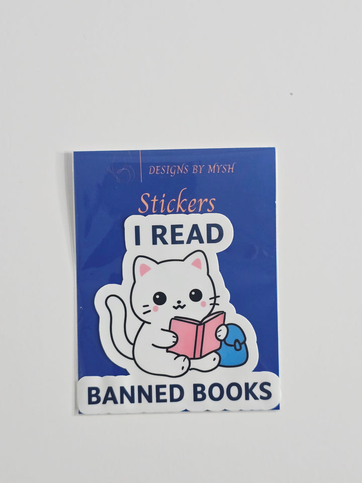 "Vinyl sticker featuring a white cartoon cat reading a pink book with the phrase &