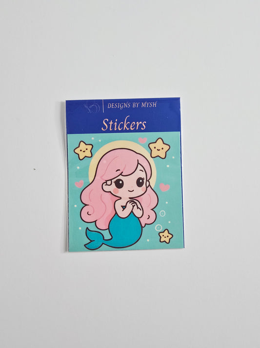 "Cartoon-style pink-haired mermaid surrounded by starfish and hearts on a turquoise background, printed on a 3-inch die-cut vinyl sticker with a glossy laminate overlay."
