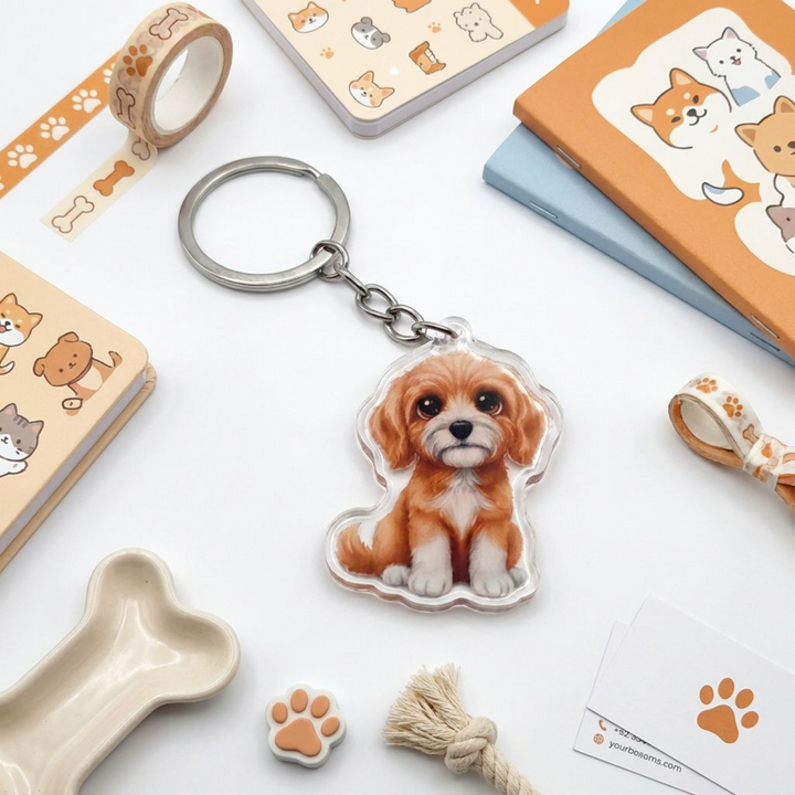 Apricot and white Goldendoodle acrylic keychain in a styled flat-lay with matching dog-themed stationery and accessories