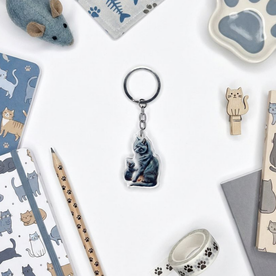 Russian Blue cat and kitten acrylic keychain in a styled flat-lay with matching cat-themed stationery and accessories