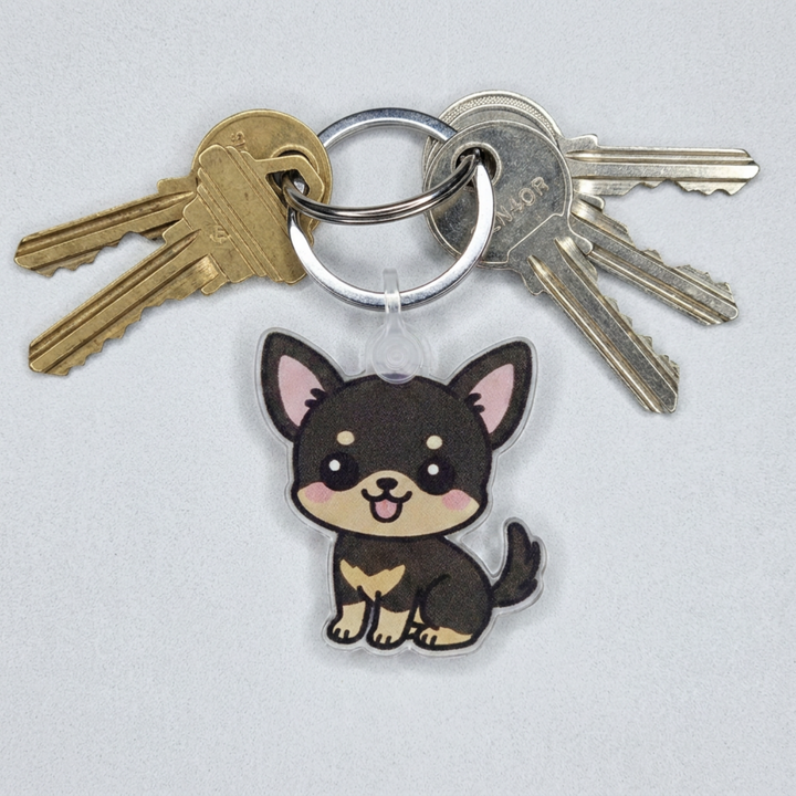 Black and tan Chihuahua acrylic keychain attached to a keyring with house keys