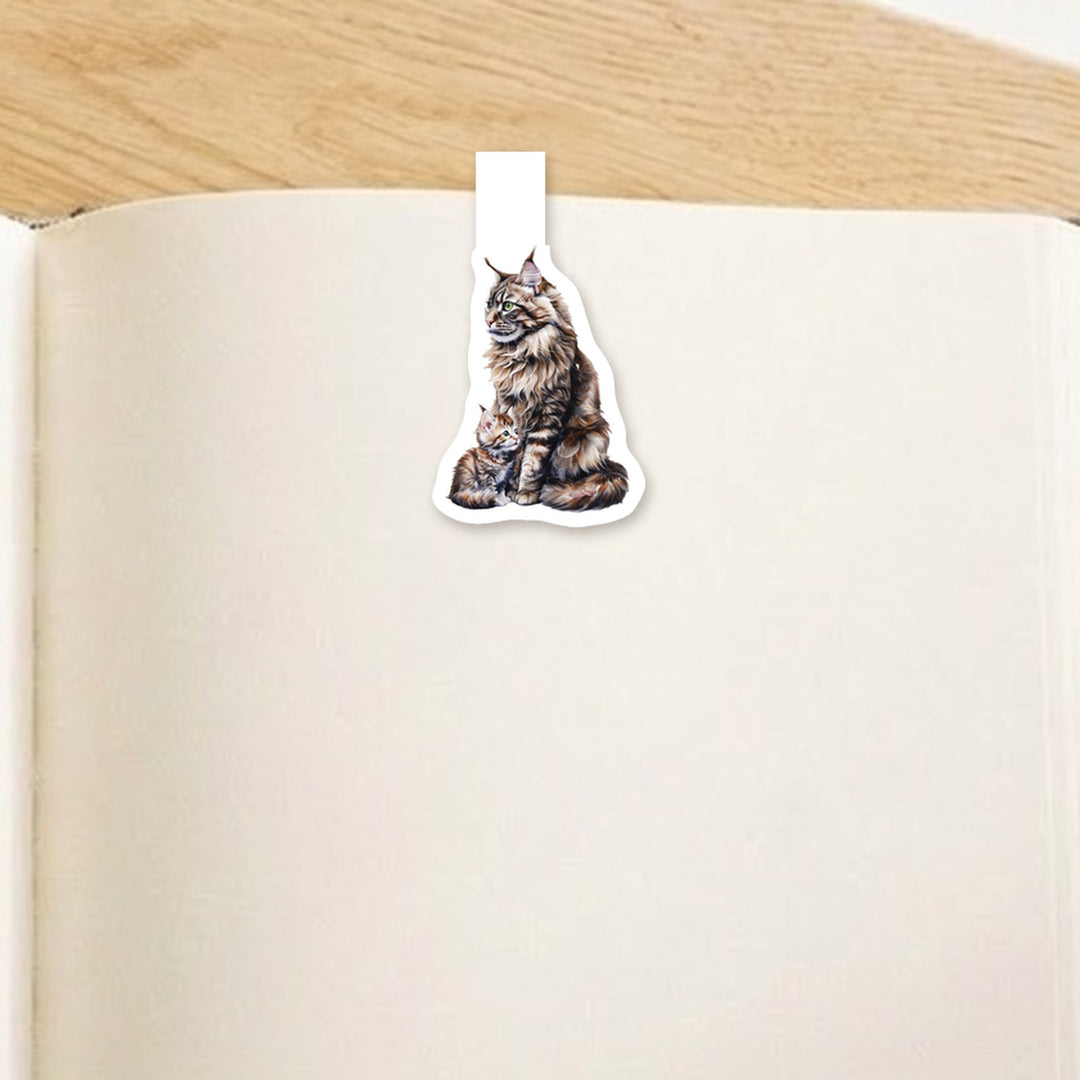 Brown tabby Maine Coon mama cat and kitten magnetic bookmark clipped over the top of an open book page – Designs by Mysh