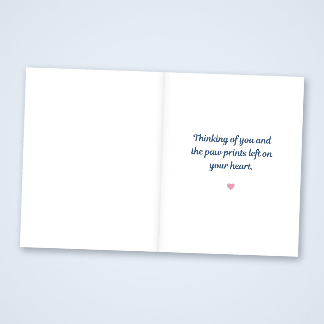 Inside of the dog pet sympathy card reading Thinking of you and the paw prints left on your heart, with a blank left side for a note