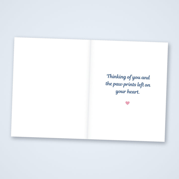 Inside of the dog pet sympathy card reading Thinking of you and the paw prints left on your heart, with a blank left side for a note