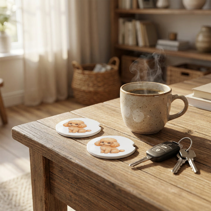 Poodle car coasters with an apricot coat styled on a wooden side table beside a steaming coffee mug and a set of keys.