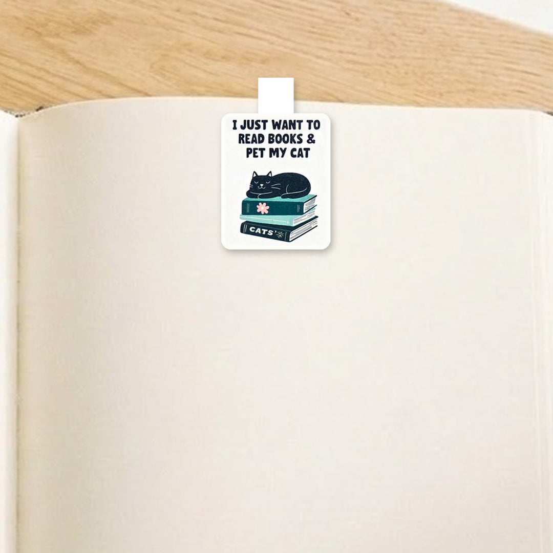 "I just want to read books and pet my cat" black cat magnetic bookmark clipped over the top of an open book page – Designs by Mysh