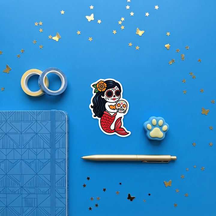 Red tail sugar skull mermaid 3 inch sticker flat lay with blue stationery – Designs by Mysh