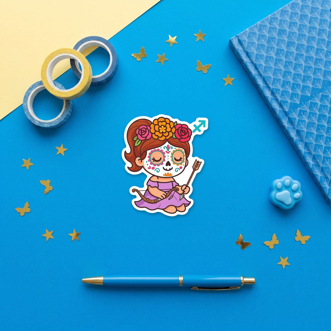 Sagittarius sugar skull girl 3 inch sticker flat lay with blue and yellow stationery – Designs by Mysh