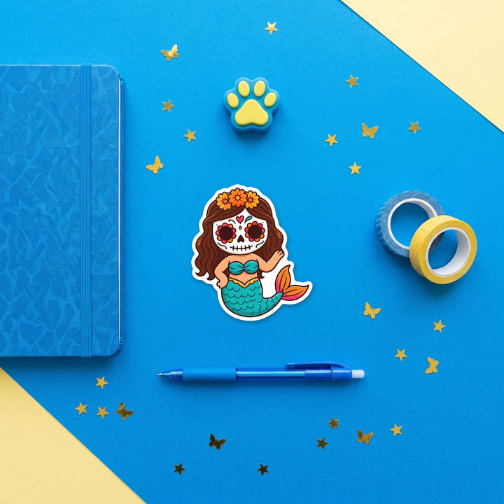 Sugar skull mermaid 3 inch sticker flat lay with blue and yellow stationery – Designs by Mysh