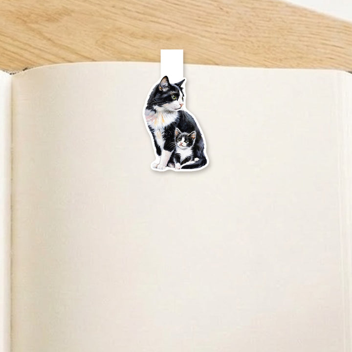 Tuxedo mama cat and kitten magnetic bookmark clipped over the top of an open book page – Designs by Mysh