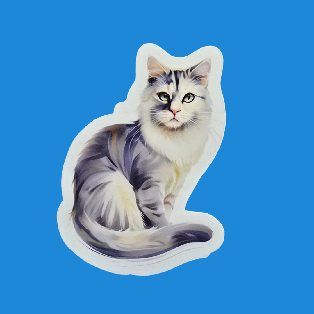 A die-cut sticker featuring a painted gray and white cat with green eyes, shown on a solid blue background.