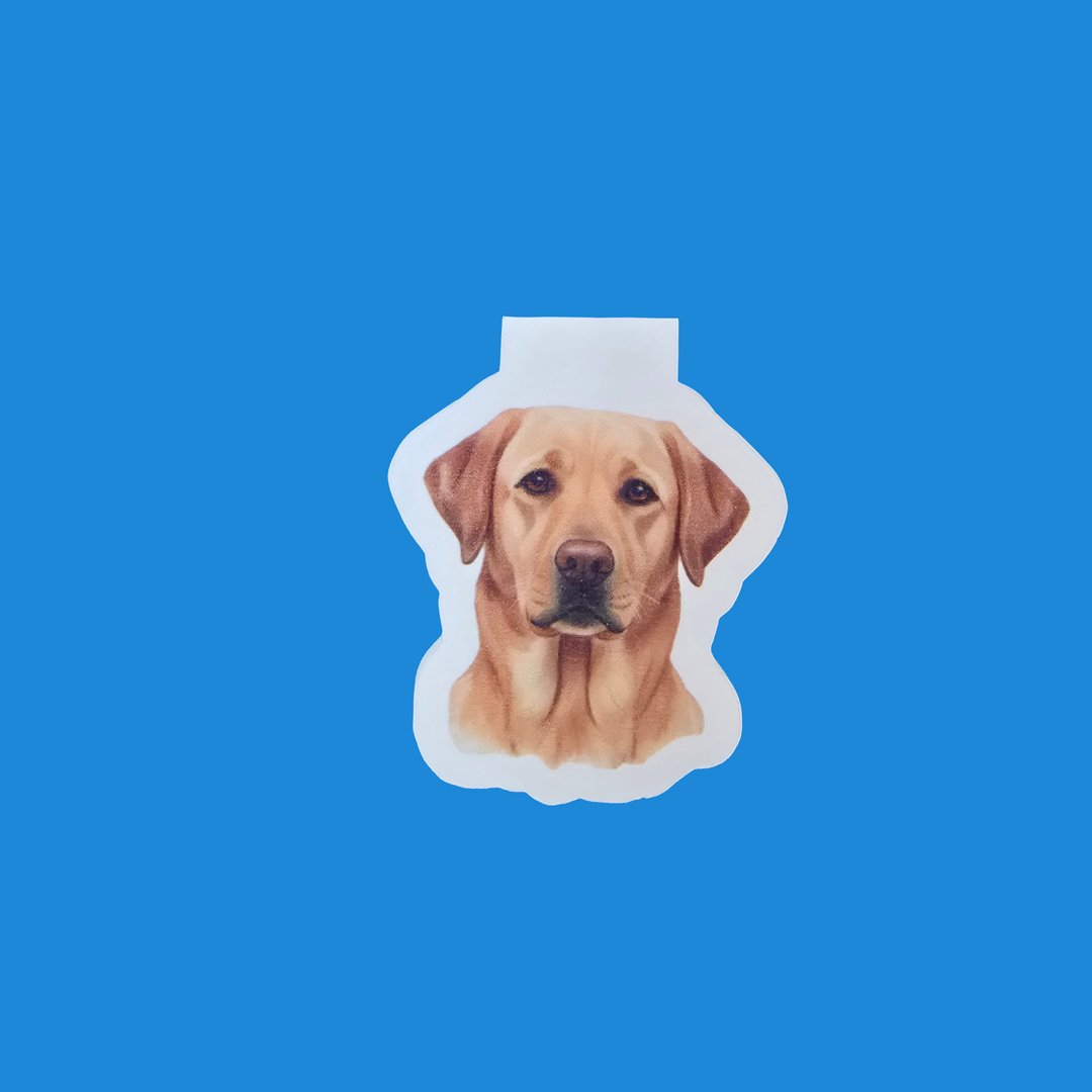 A die-cut sticker featuring a realistic portrait of a yellow Labrador Retriever dog's face, shown on a solid bright blue background.