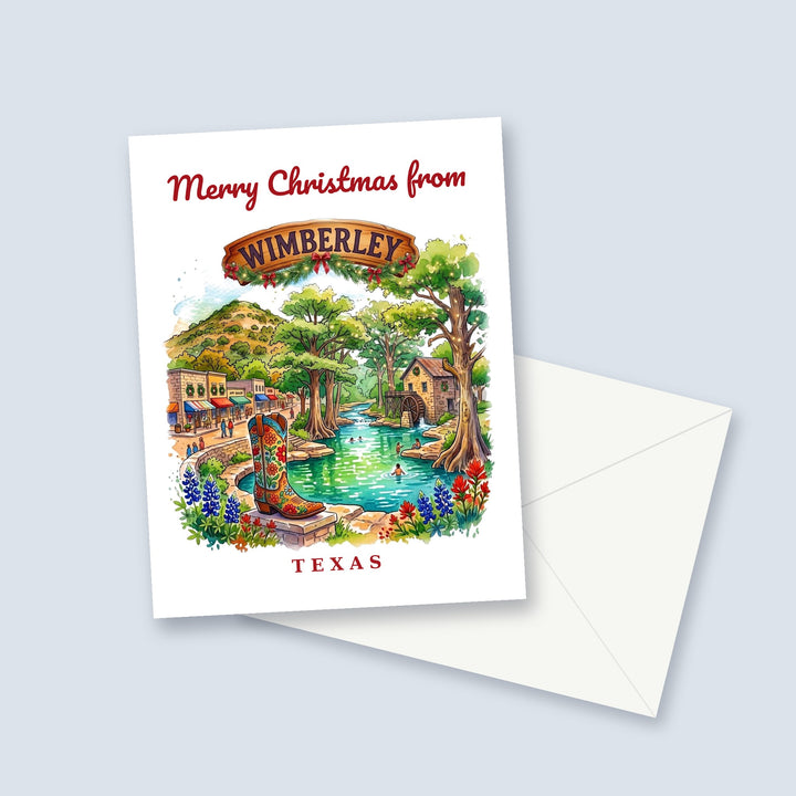 Merry Christmas from Wimberley Texas watercolor Christmas card with a cowboy boot, Cypress Creek and bluebonnets, a garland-trimmed town sign and a white envelope
