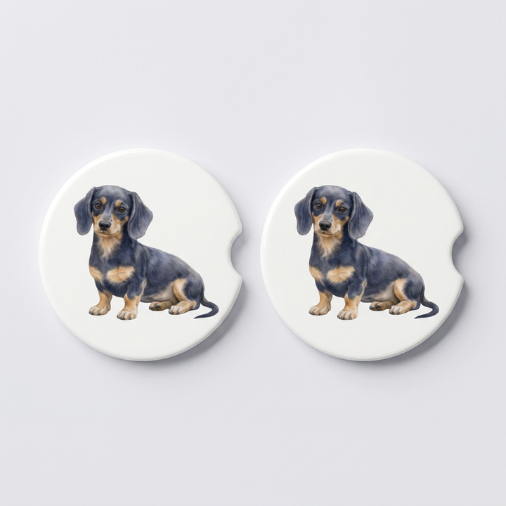 Set of two round ceramic car coasters featuring a watercolor-style illustration of a Dachshund with a blue and tan coat.