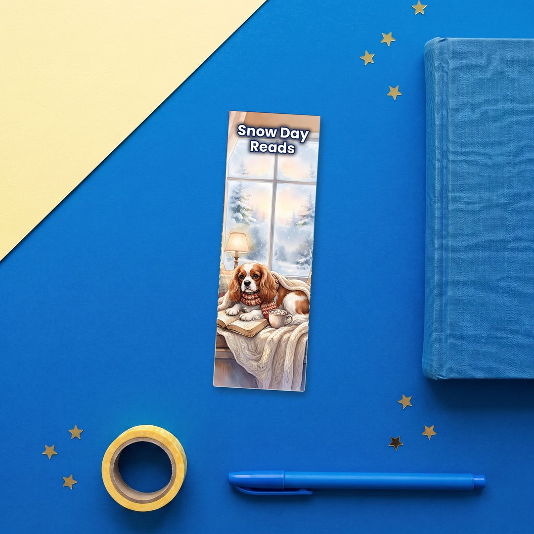 Snow Day Reads Cavalier King Charles watercolor bookmark flat lay with blue stationery – Designs by Mysh