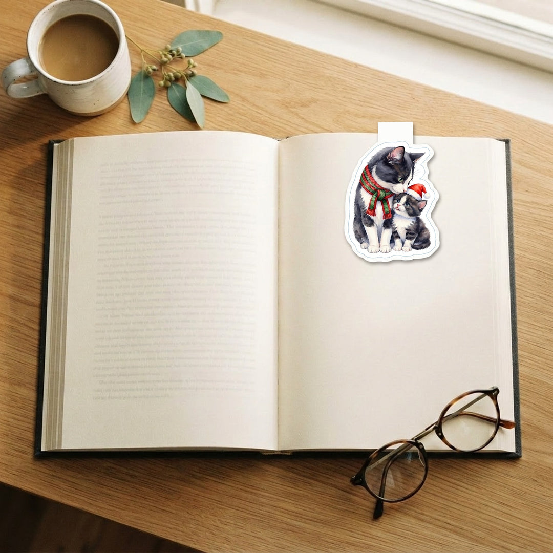 Tuxedo mama cat and kitten Christmas magnetic bookmark clipped on an open book – Designs by Mysh
