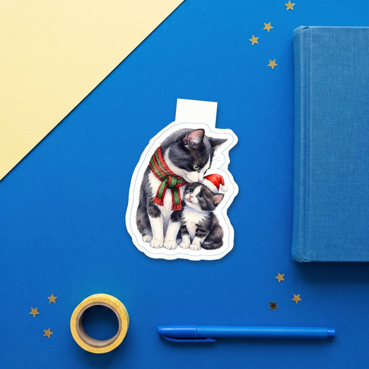Tuxedo mama cat and kitten Christmas magnetic bookmark flat lay with blue stationery – Designs by Mysh