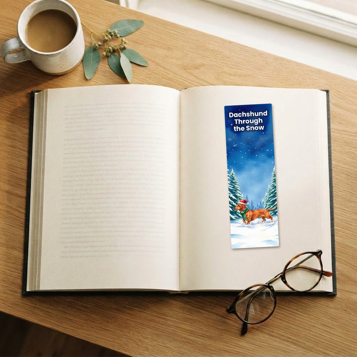 Dachshund Through the Snow watercolor bookmark on an open book – Designs by Mysh